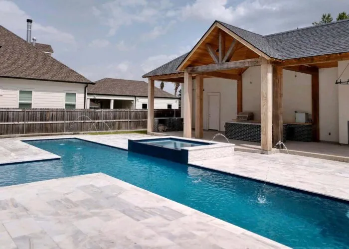 geometric pool in backyard with fountain