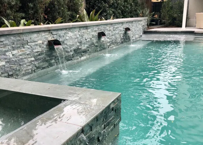 pool & spa water feature in backyard