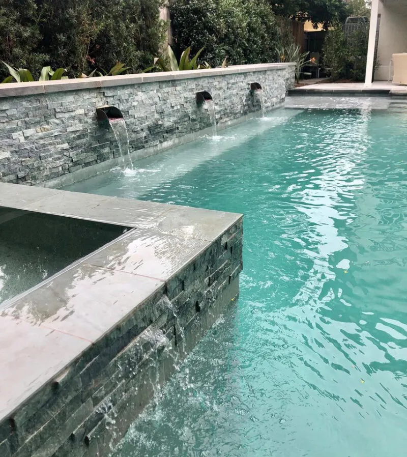 pool & spa water feature in backyard